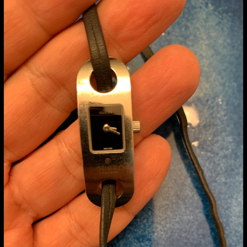 Gucci watch that has a black leather band